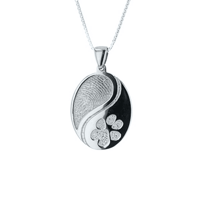 GIF of silver pendant with two engraved designs. 