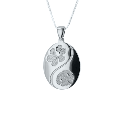 GIF of silver pendant with engraved designs. 